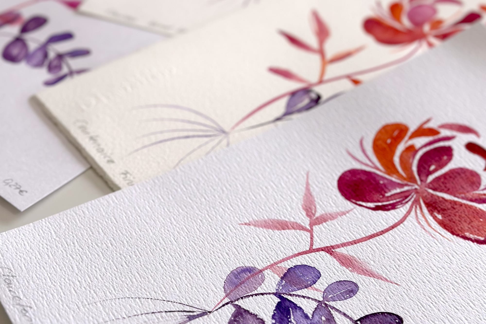 Floral watercolor motifs in pink, red and violet on fine paper