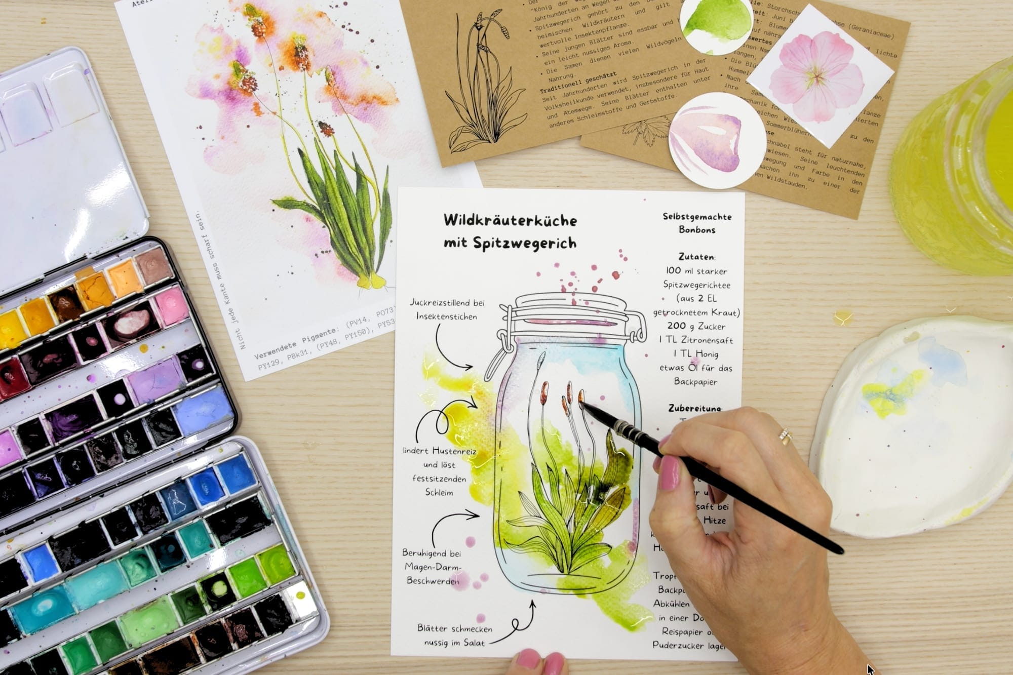 The colored ribwort plantain in a jar on the recipe sheet, with the candy recipe beside it
